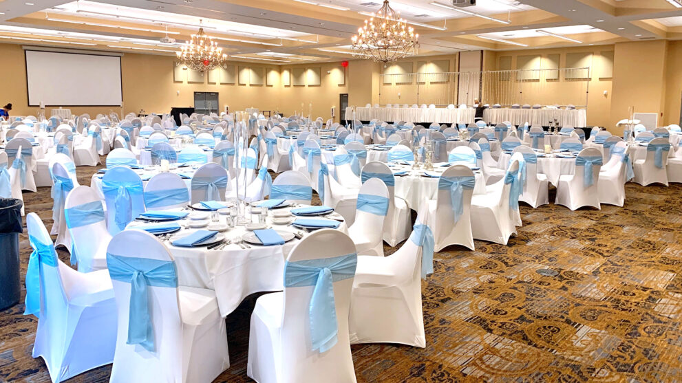 White and blue table and chairs in event hall