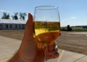 A glass of white wine outside of Schade Winery and Vineyard