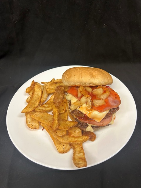 A burger with pineapple chunks and a side of fries